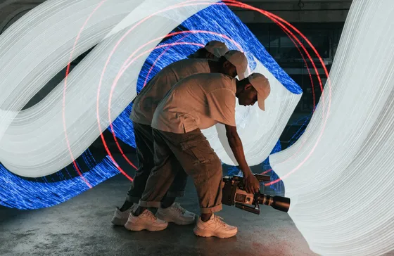 Campaign visual — filmmaker at work in pearl light